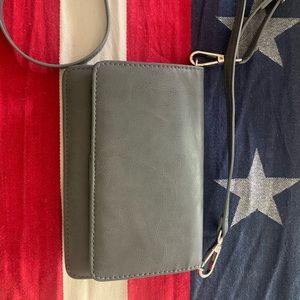 Gray crossbody bag with slots for card
